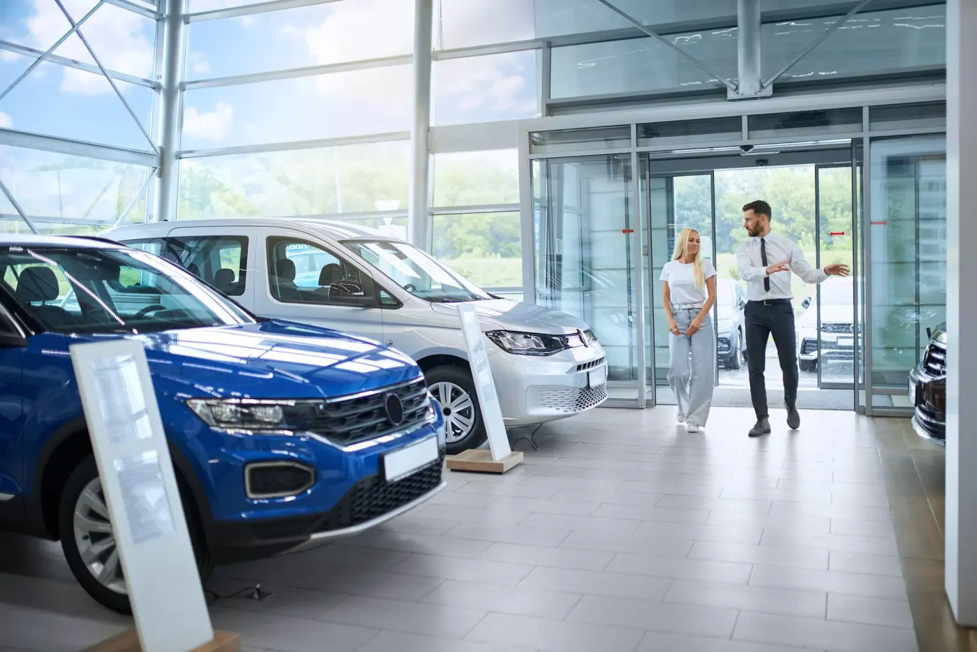 Car buyers with a new car at a dealership
